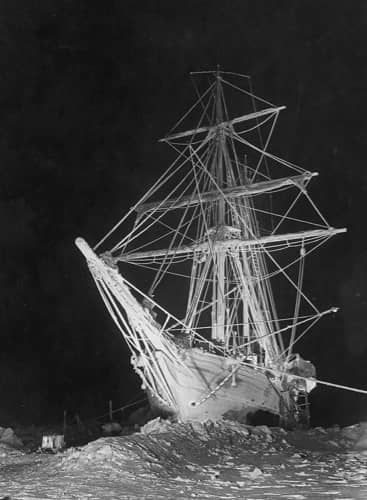 An inverse black and white photograph of the ice stricken ship the Endurance.